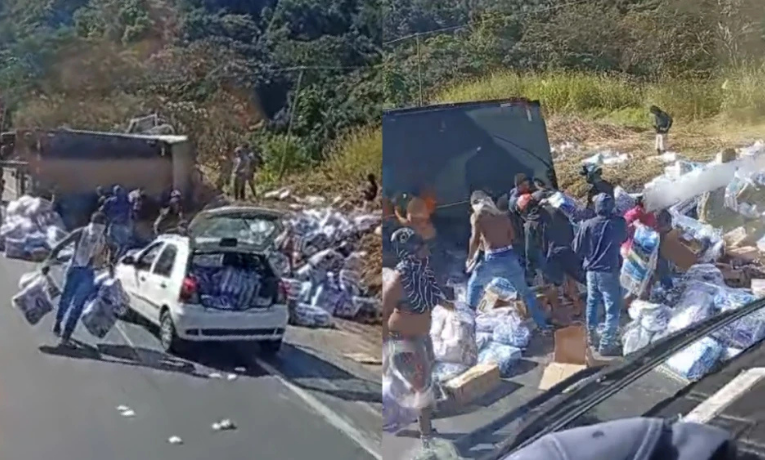 Caminhão carregado com fraldas tomba na BR-381, em São Gonçalo do Rio Abaixo (MG), e carga é saqueada por populares. PRF interdita parcialmente a via.